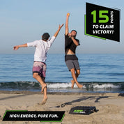 two men catching ball in the air on a beach